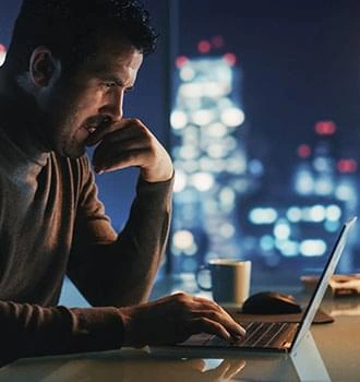 A man working late at a laptop, stock imagery from The supplier