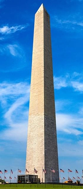 A tall stone monument against a blue sky, stock imagery from The supplier