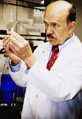 A scientist holding a vial in a laboratory, stock photography